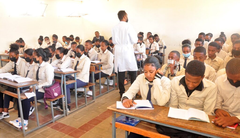 A cross-section of a teacher in a classroom filled with students in Eritrea