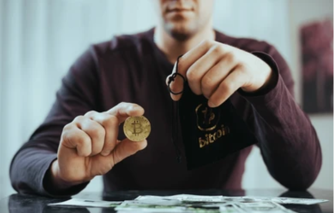 A man holding a bitcoin