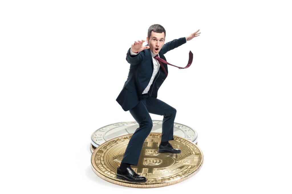 Businessman standing on cryptocurrencies and feeling excited about its future 