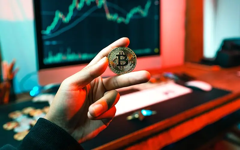 A person holding a Bitcoin 