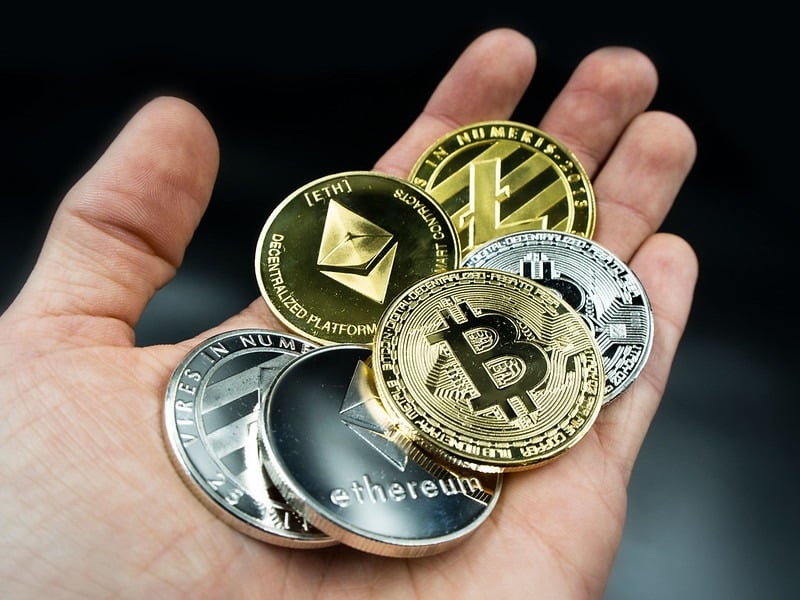 A hand with crypto coins in them 