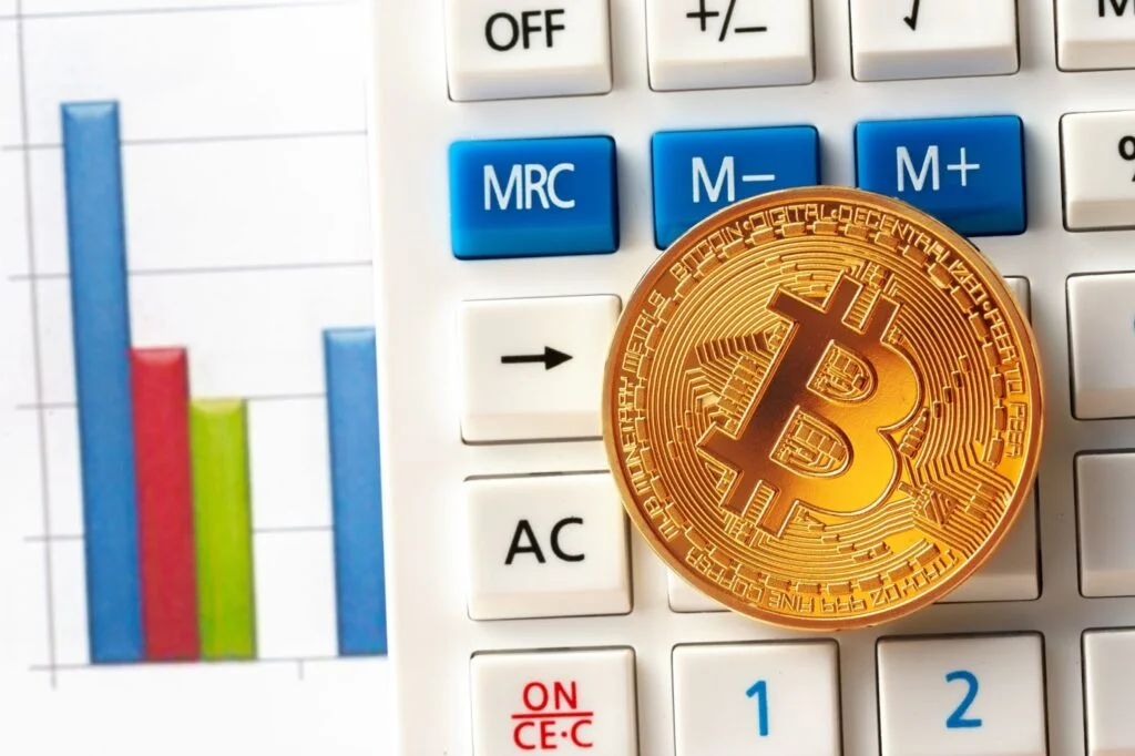 Bitcoin coin on calculator
