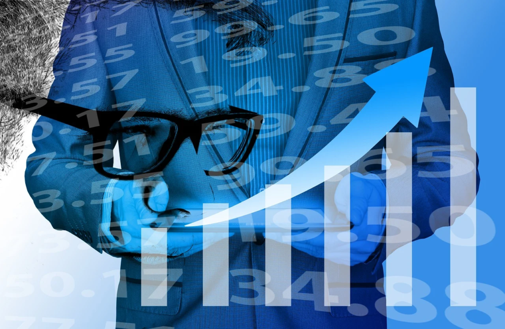 a conceptual image of a man in a blue suit studying the charts on his tablet.