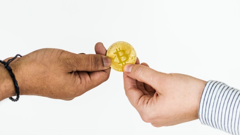 Closeup of exchanging bitcoin isolated on white background.