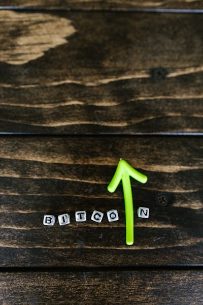 Letter Beads and Green Arrow on a Wooden Surface