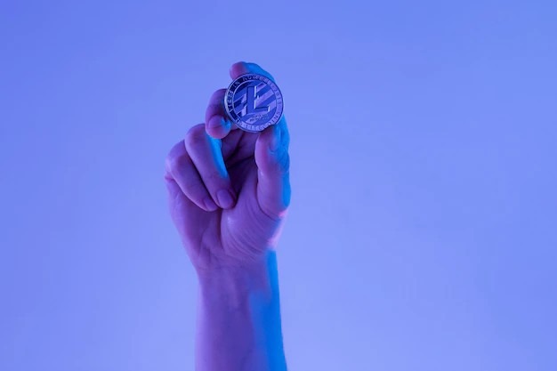 Selective Male Hand with Golden Litecoin Coin   