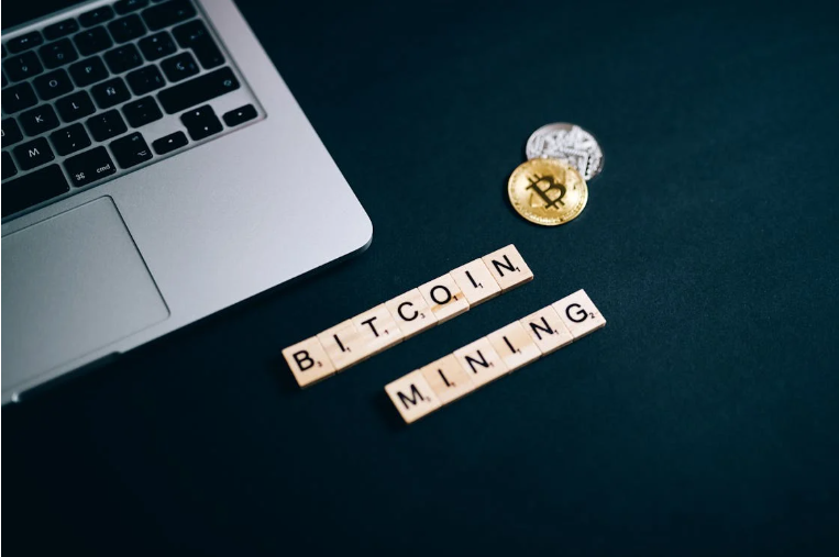 Bitcoin with Bitcoin mining write up and a laptop
