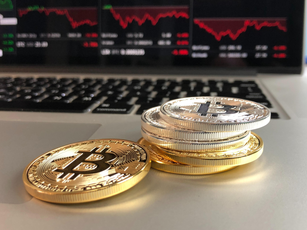 Physical Bitcoin tokens placed on a laptop keyboard
