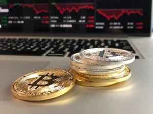 Physical Bitcoin tokens placed on a laptop keyboard